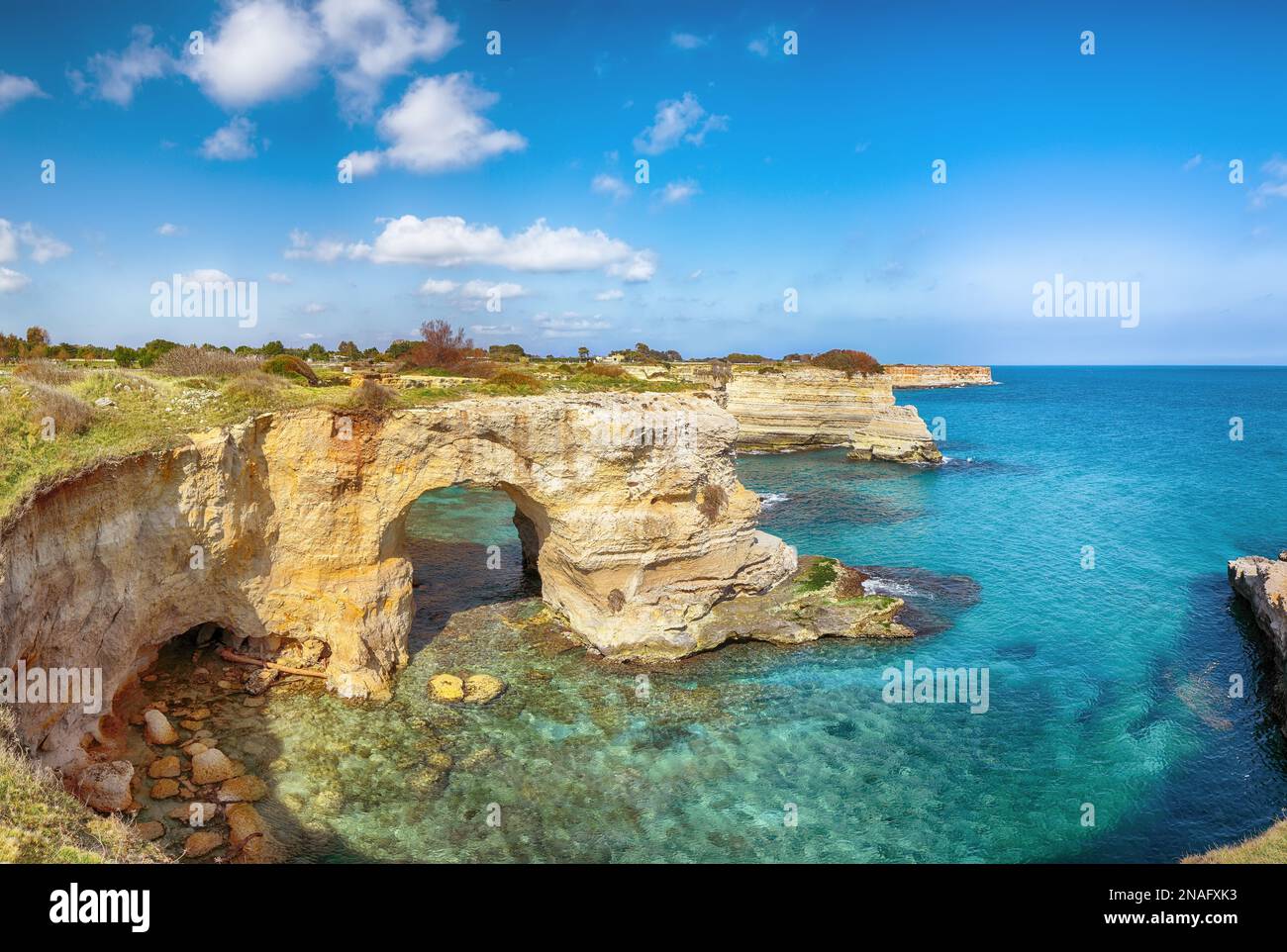 Stunning seascape with cliffs rocky arch and stacks (faraglioni) at Torre Sant Andrea, Salento coast, Puglia region, Italy Stock Photo