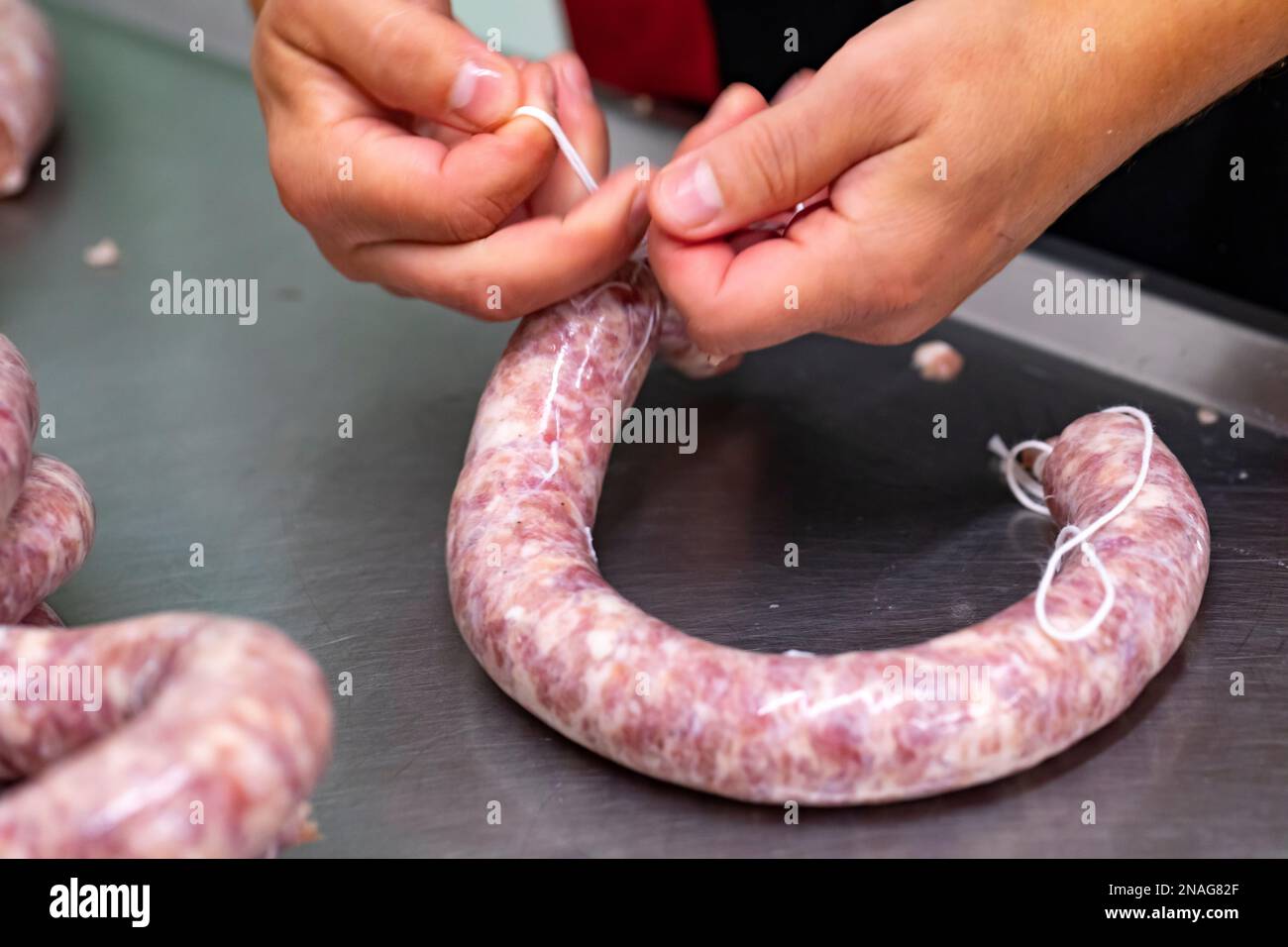 Making of llonganissa (cured & dried pork sausage) Stock Photo