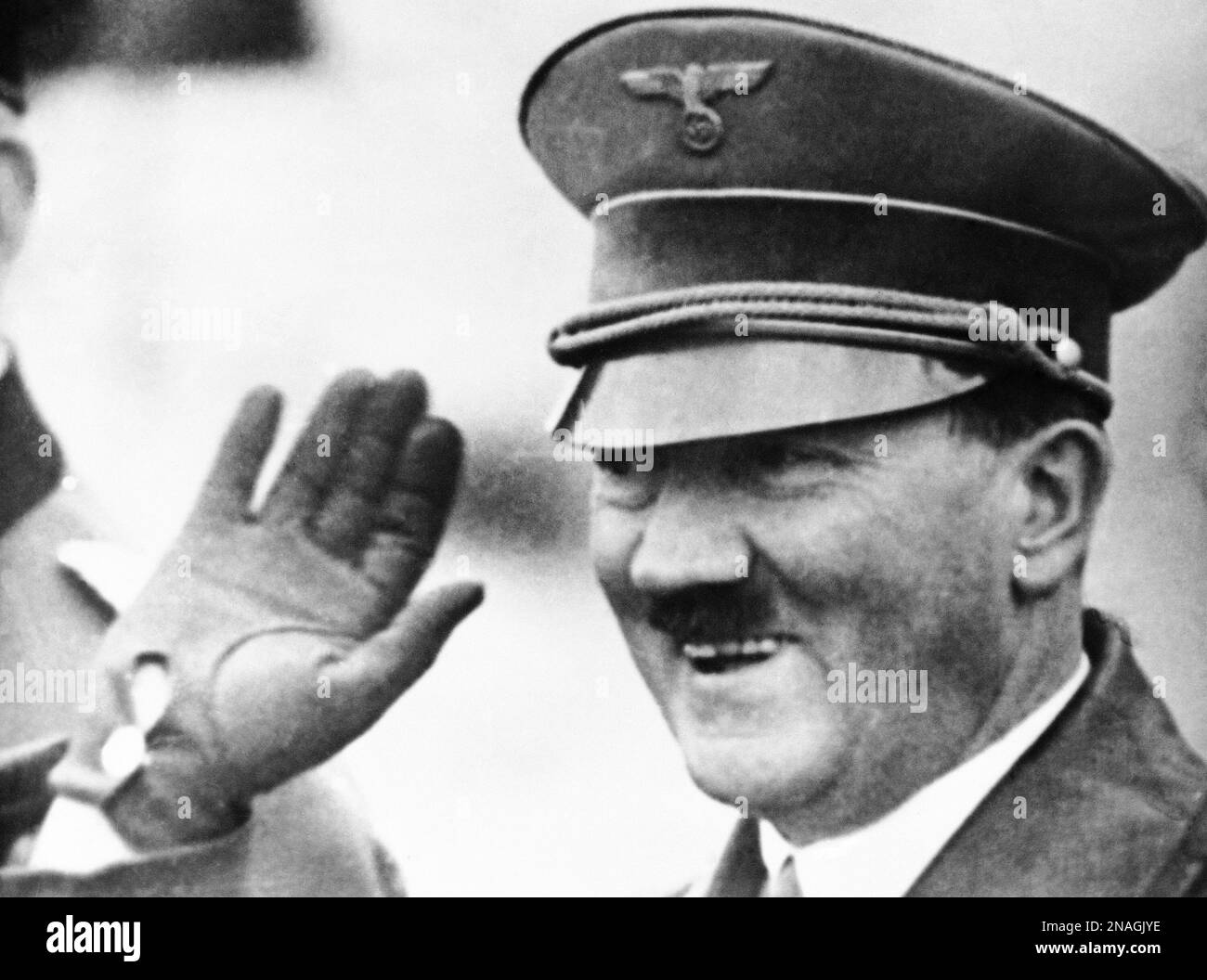 German Chancellor Adolf Hitler greets the crew of a man-of-war with a smile, in Germany, on Feb. 19, 1937. (AP Photo) Stock Photo