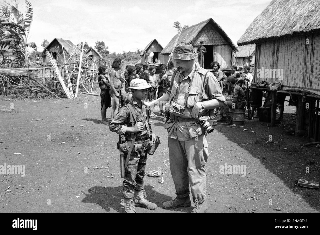 Associated Press photographer Eddie Adams with a village child during