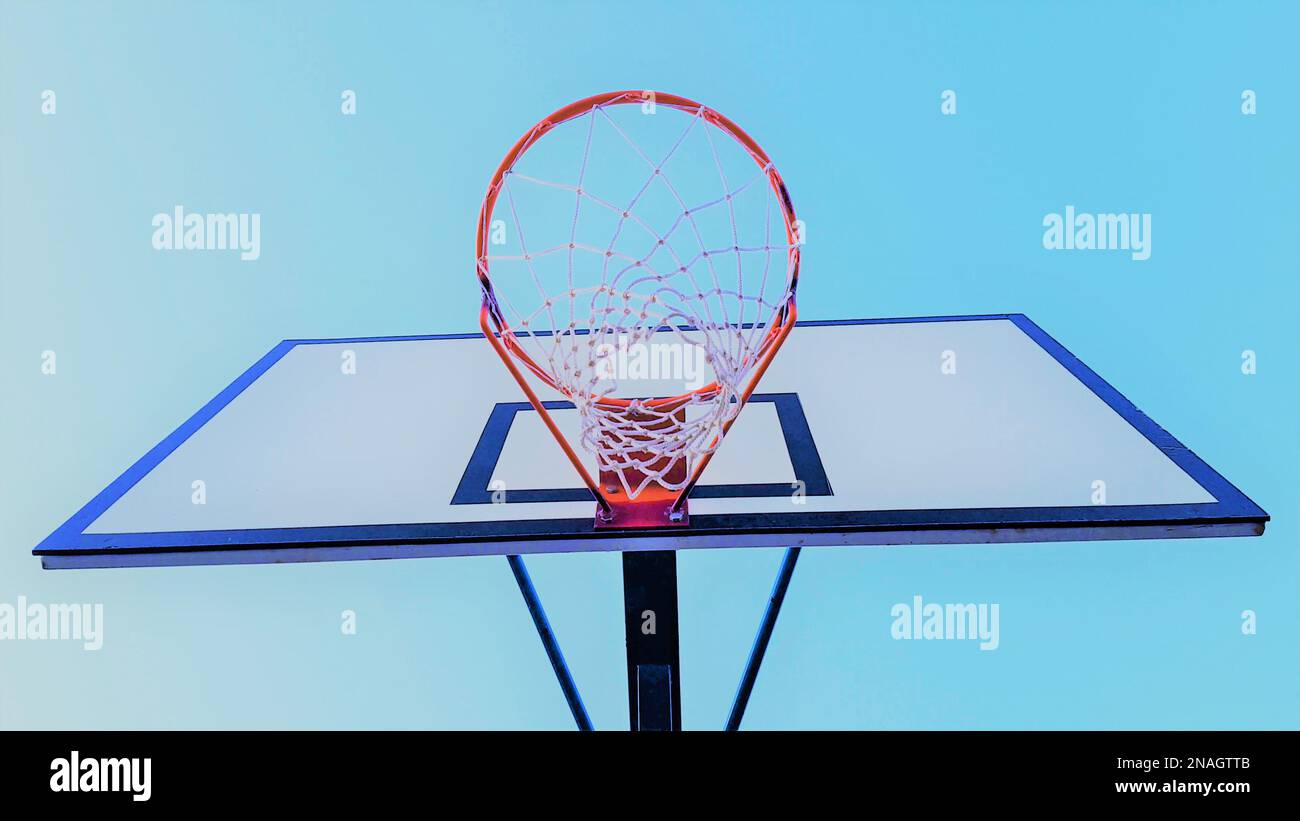 basketball hoop on blue sky background, bottom view. Stock Photo