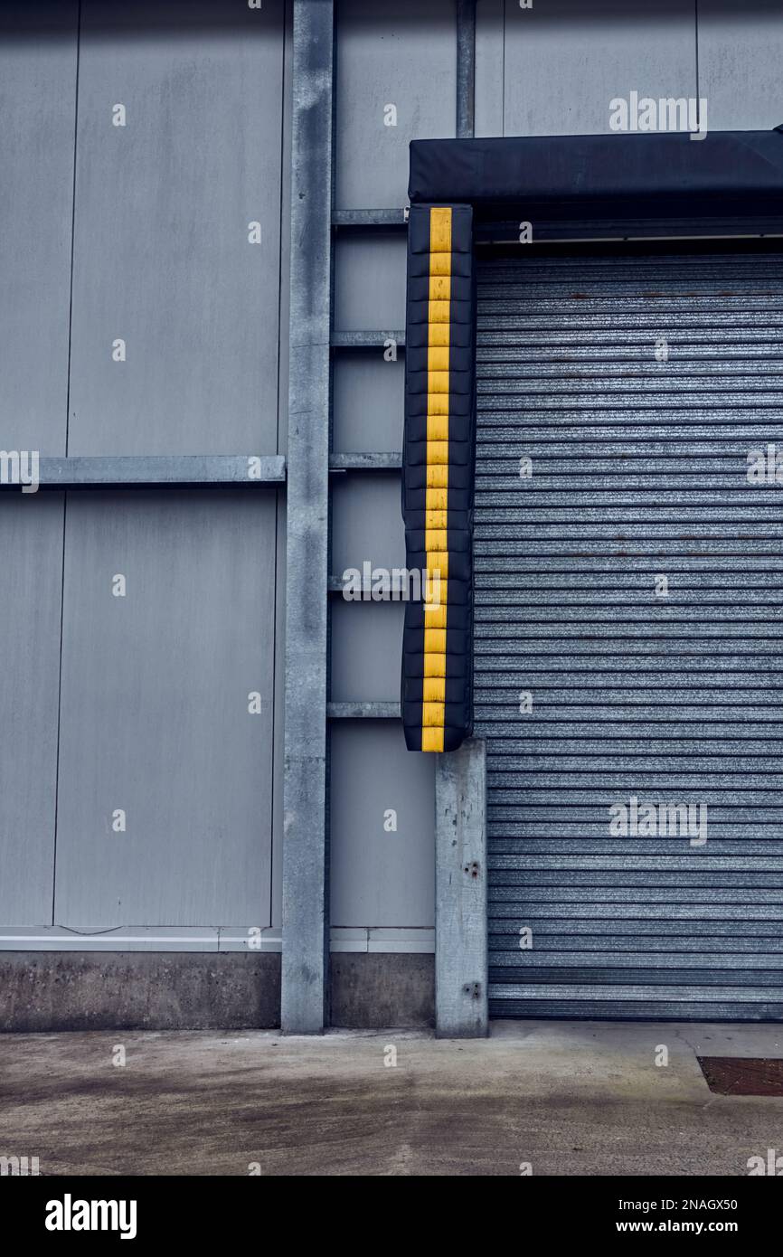 A large rollered door in a modern warehouse building. Stock Photo