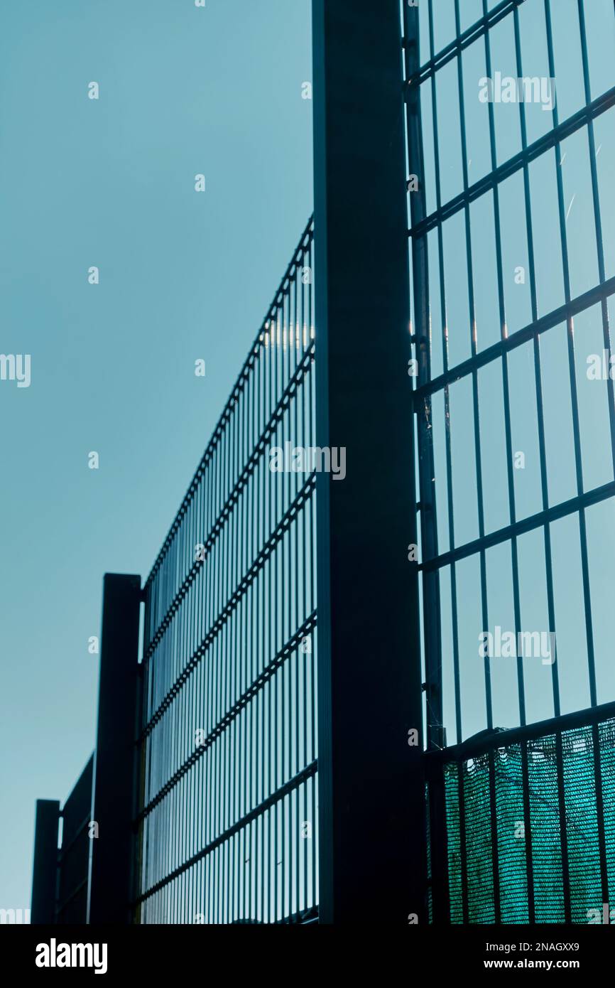 High metal fencing against the sky. Stock Photo