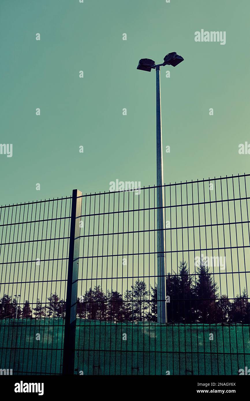 Floodlights and fencing at a football pitch Stock Photo Alamy