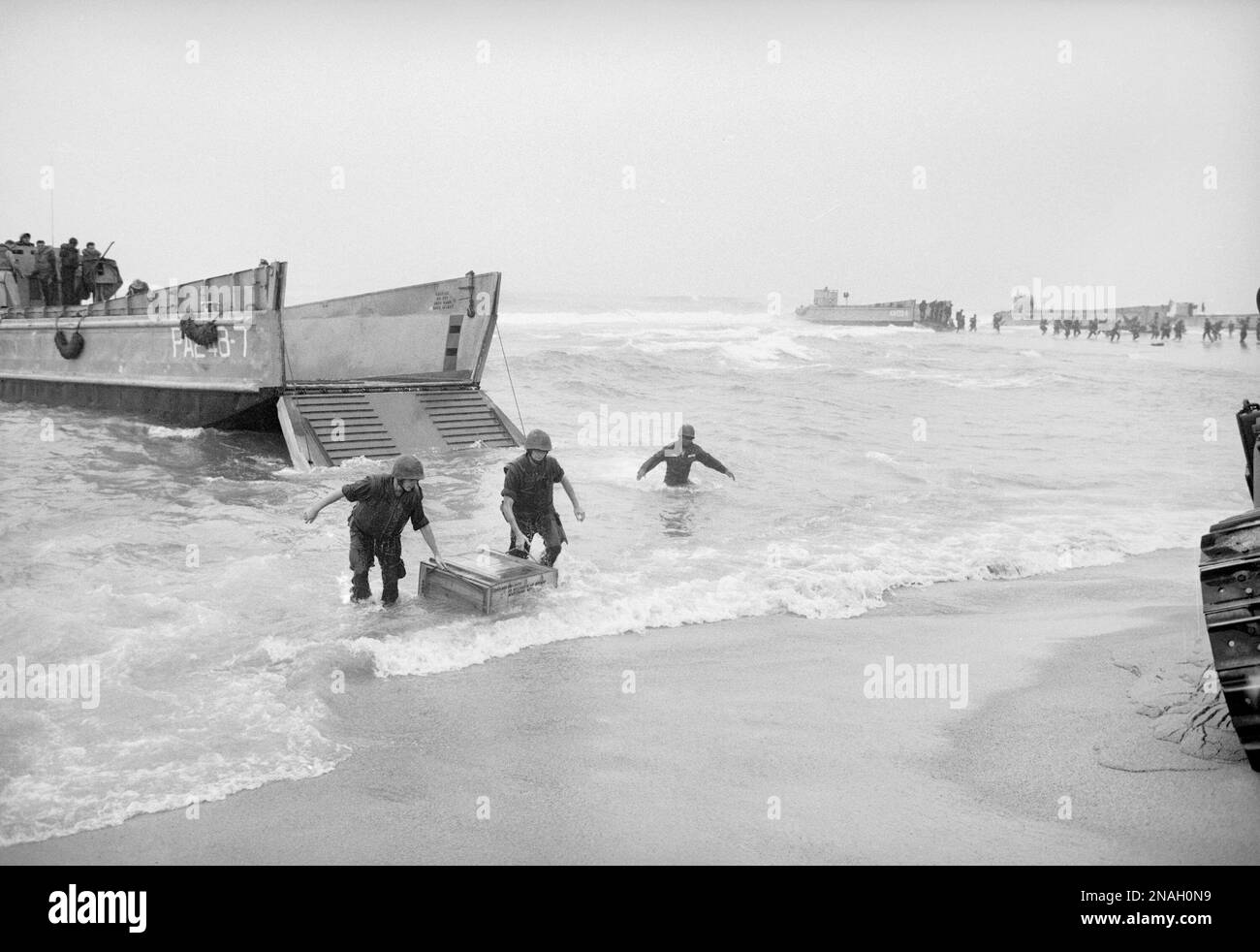 Troops unloading supplies on the beach during the Vietnam War. Location ...