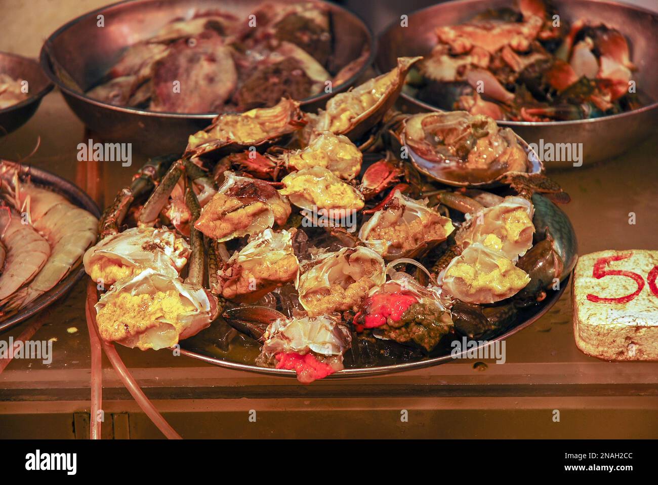 Raw crab meat cut in half. Selling fresh seafood at a fish market. Hong