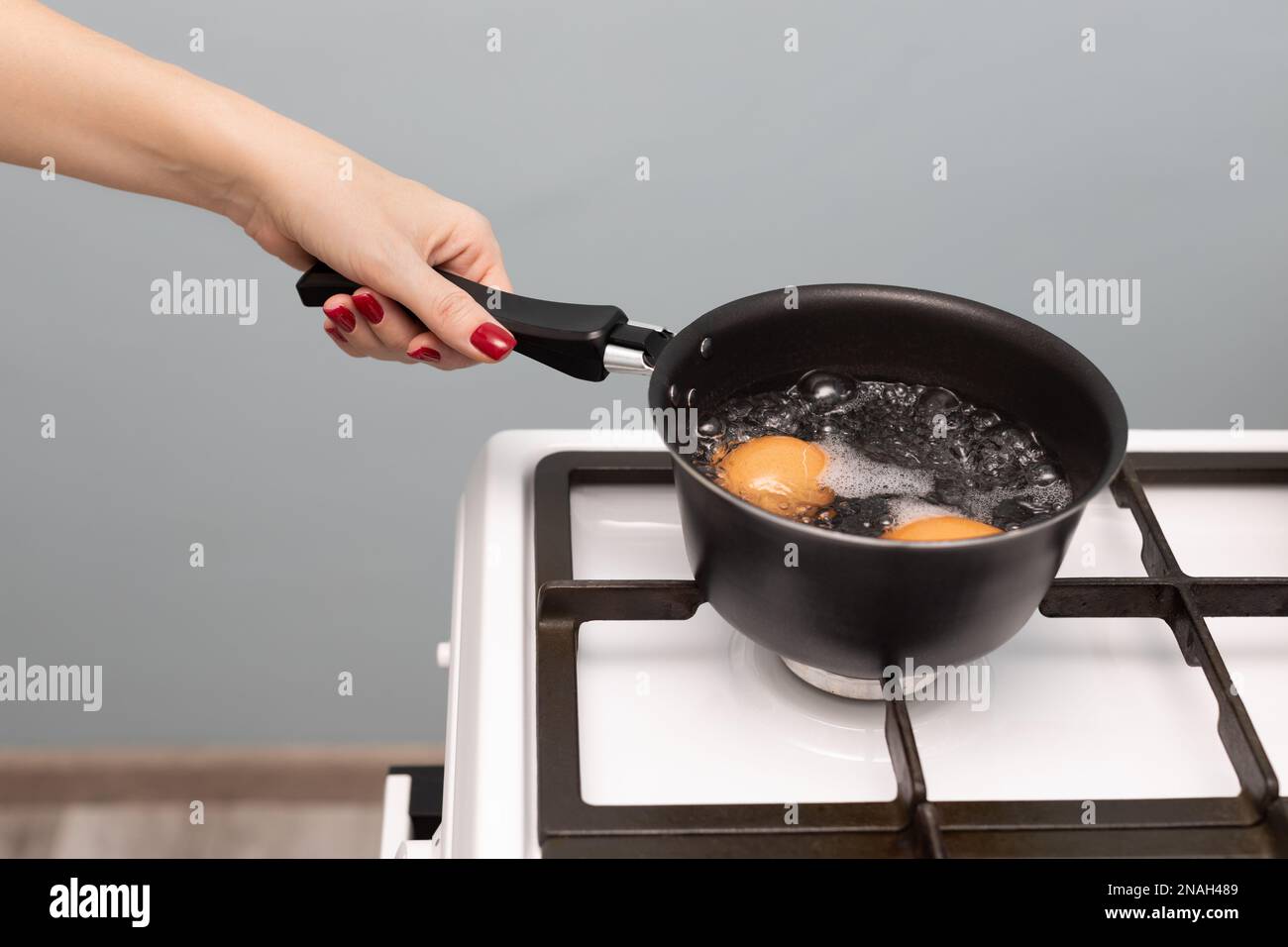 measuring temperature of fish soup during cooking in stockpot by infrared  thermometer on ceramic stove at home kitchen Stock Photo - Alamy