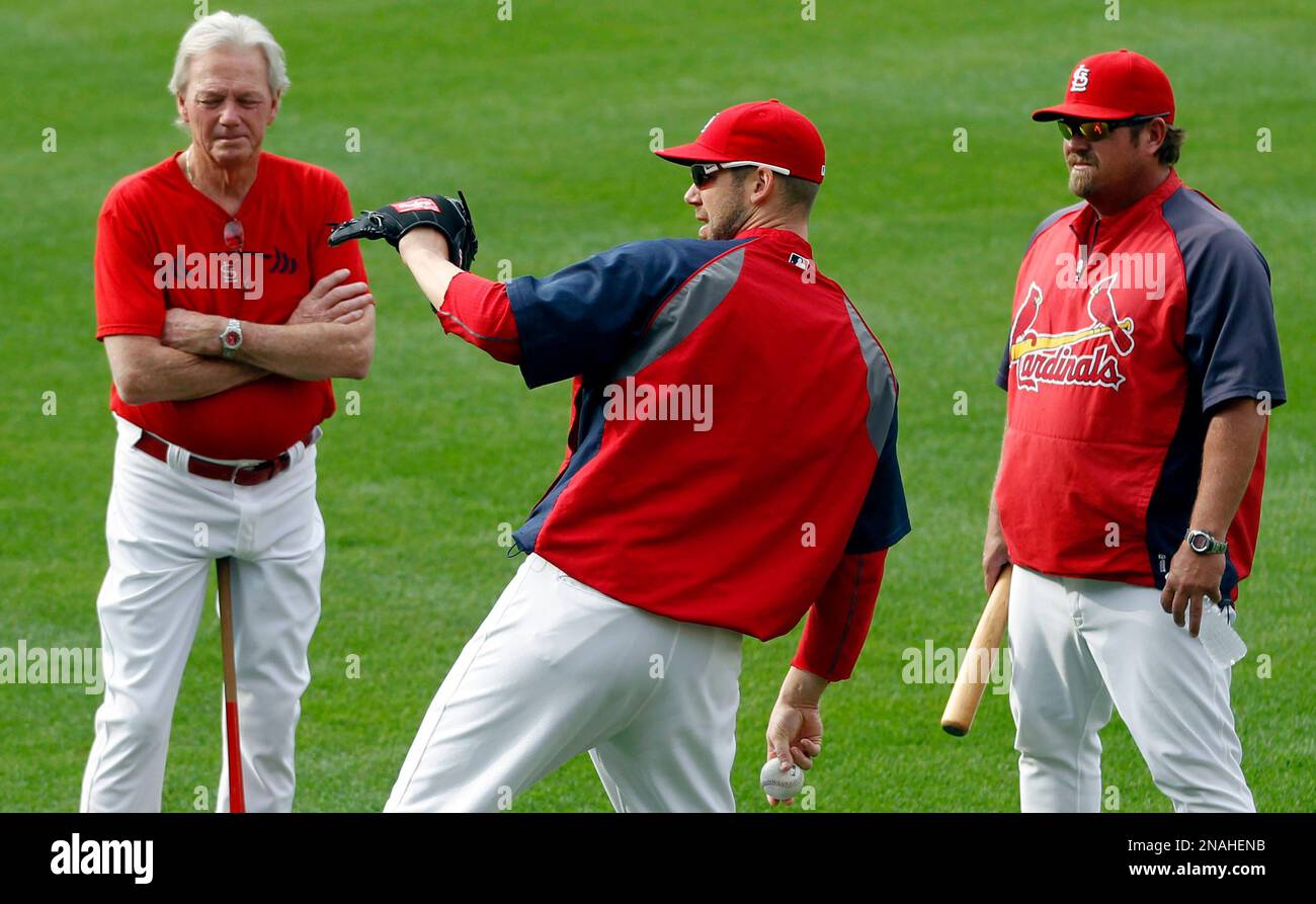 The St. Louis Cardinals' Matt Carpenter grimaces as he is escorted off the  field by trainer Chris Conroy and manager Mike Matheny, right, after  hitting a double in the first inning against