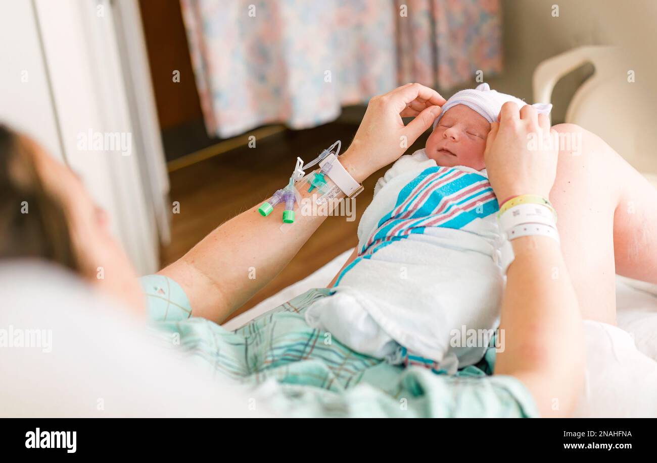 New Mother and Newborn in Hospital Room Stock Photo