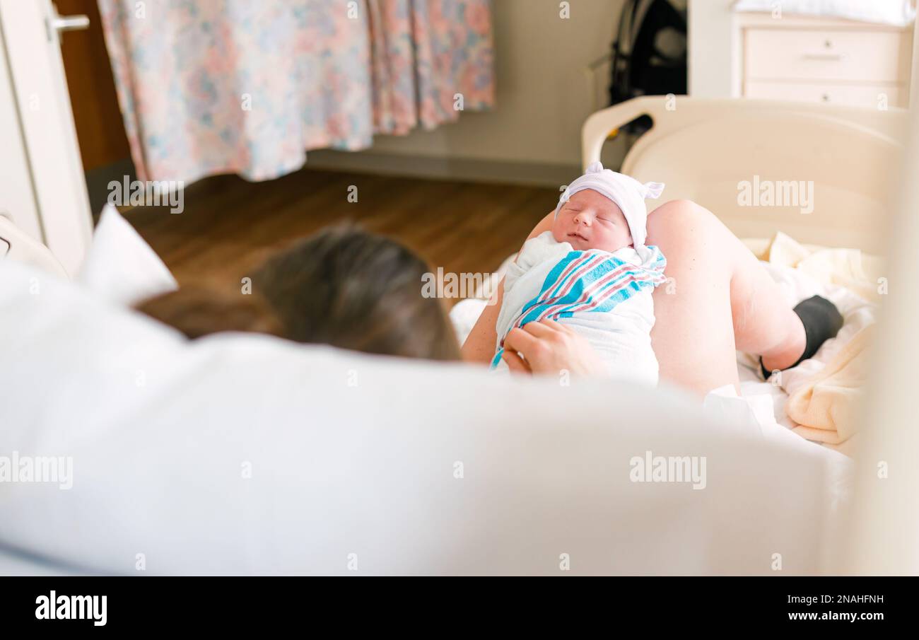 New Mother and Newborn in Hospital Room Stock Photo