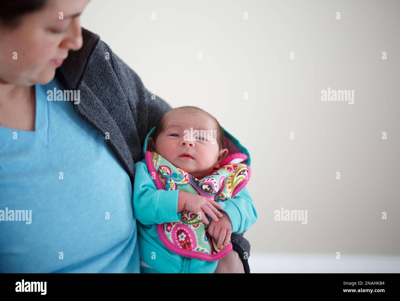 Woman Mother holding newborn baby in hospital after pregnancy labor and delivery in maternity ward Stock Photo