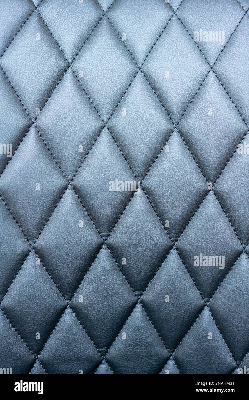 Quilted black leatherette surface close-up photography. Stock Photo