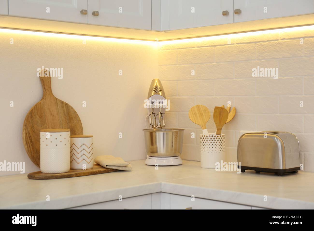 Modern toaster, mixer and utensils on counter in kitchen Stock Photo ...