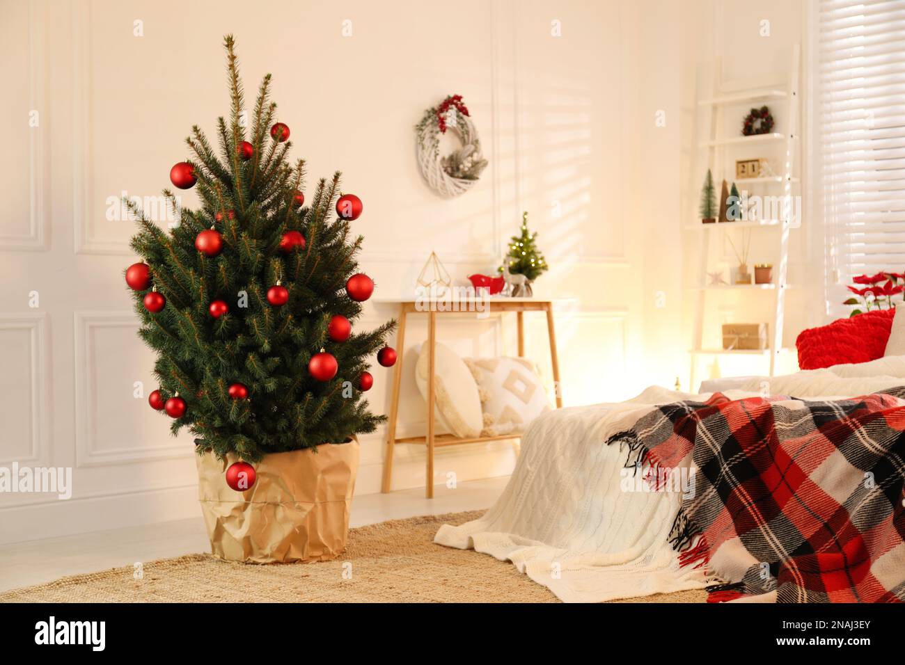 Beautiful decorated Christmas tree in bedroom. Interior design Stock
