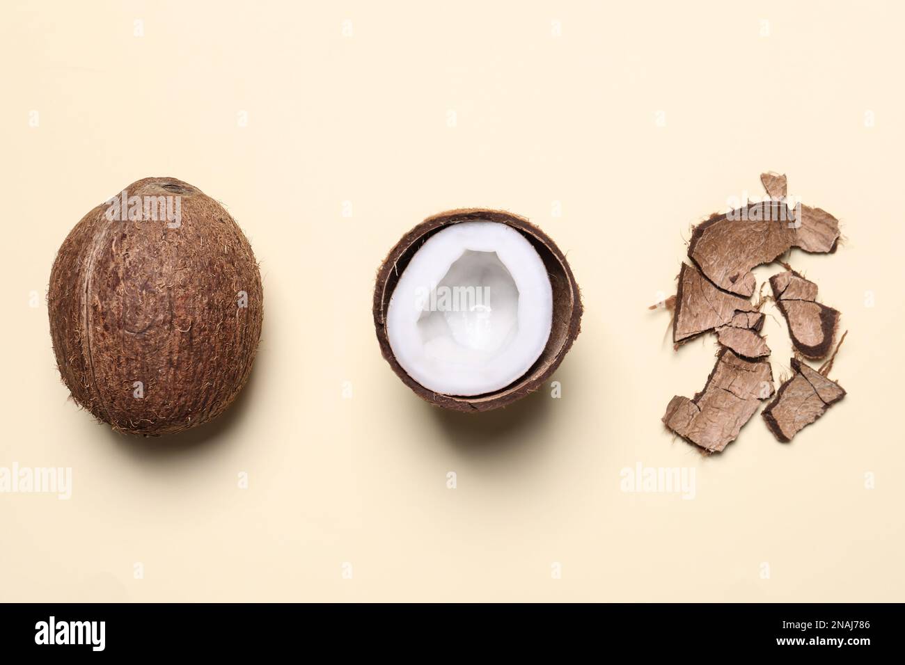 Flat lay composition with coconuts on beige background Stock Photo