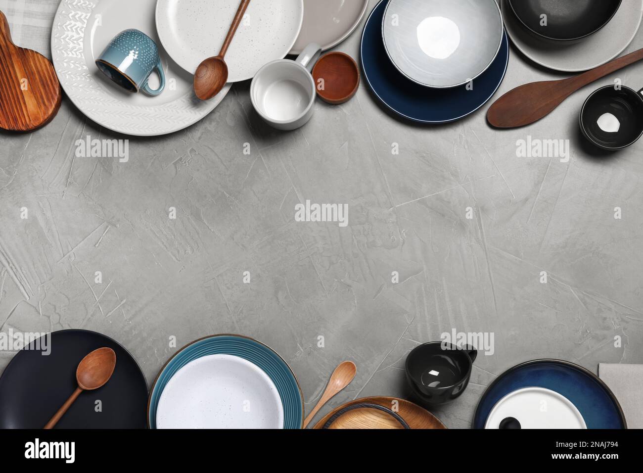 Flat lay composition with dishware on light grey table. Space for text ...
