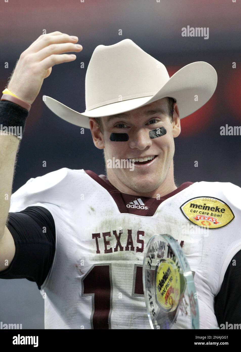 Texas A&M quarterback Ryan Tannehill (17) adjusts a cowboy hat after ...