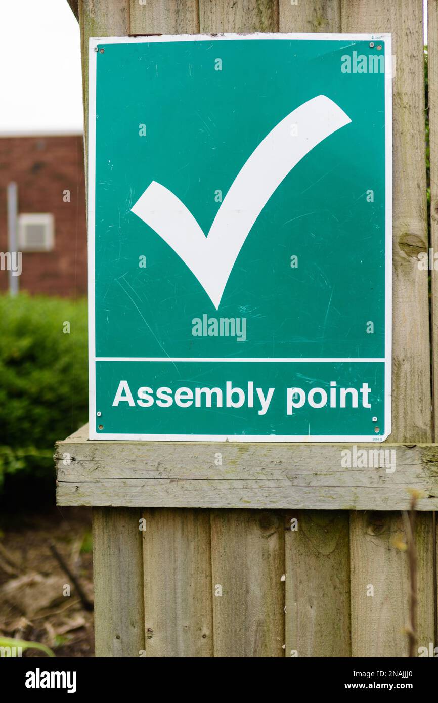 A fire assembly point sign indicates the rendezvous point in case of