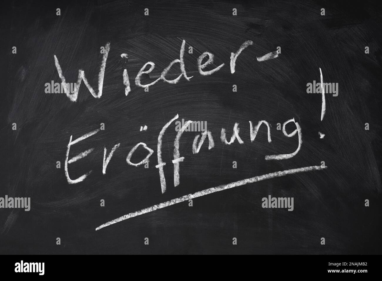 Wiedereroeffnung means reopening in German - handwritten text on chalkboard sign Stock Photo