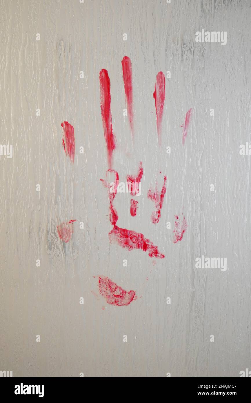 blood smeared bloody handprint on frosted glass window or shower screen