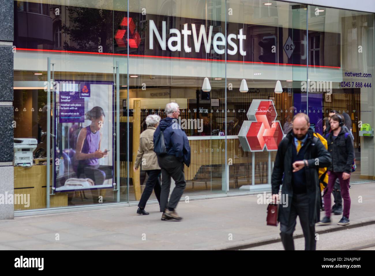 People walk past a branch of Natwest bank in Manchester city centre Stock Photo