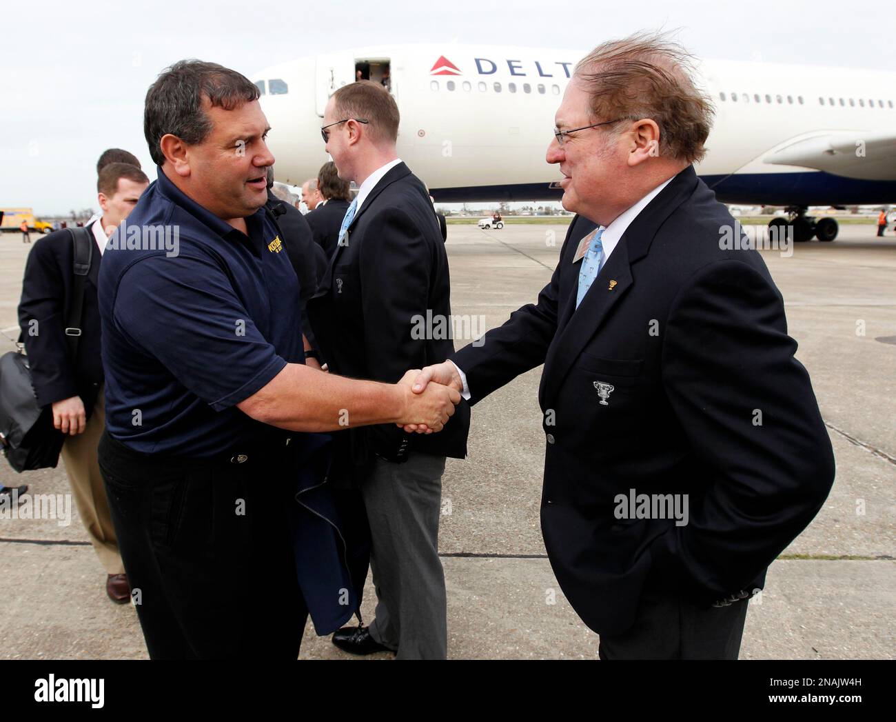 Michigan head coach Brady Hoke, left, shakes hands with Sugar Bowl