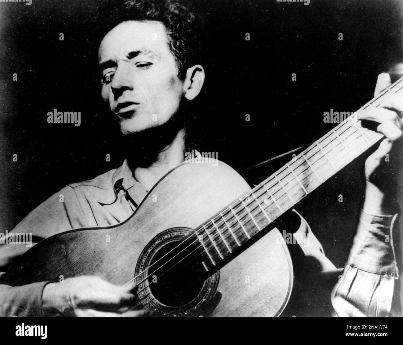 FILE This Undated File Photo Shows Folk Singer Woody Guthrie Playing top-country-songs-of-all-time-great-country-songs-of-all-time-youtube