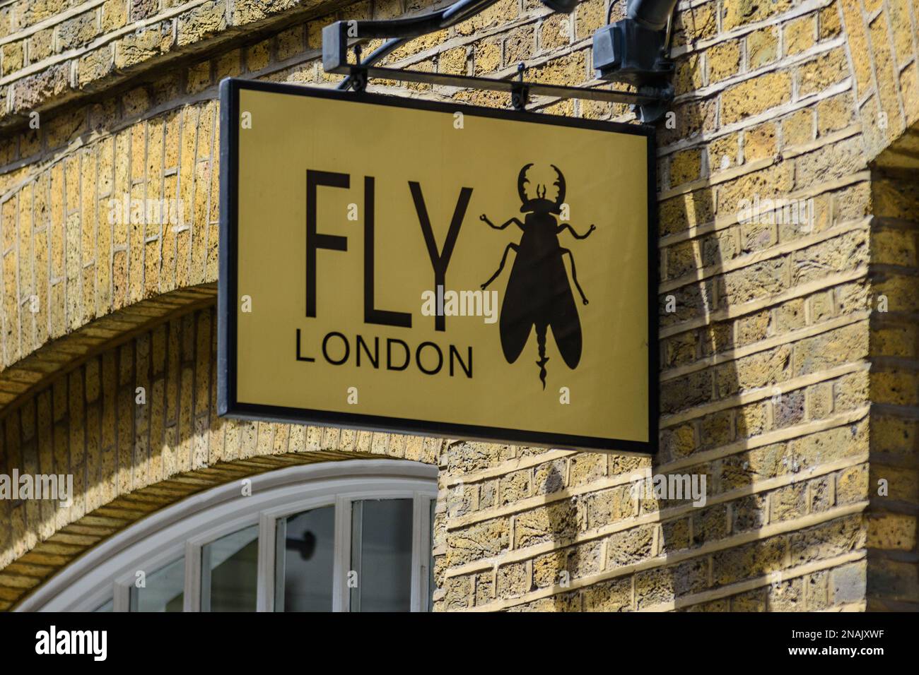 A shop sign outside a Fly London shoe shop in central London advertises their luxury brand to shoppers, tourists and passers by. Stock Photo