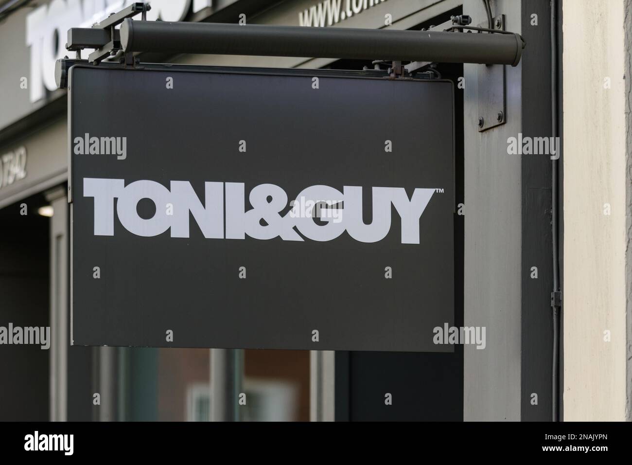 A sign outside a Toni and Guy hair salon in central London advertises their hairdressing and beauty services to men and women Stock Photo