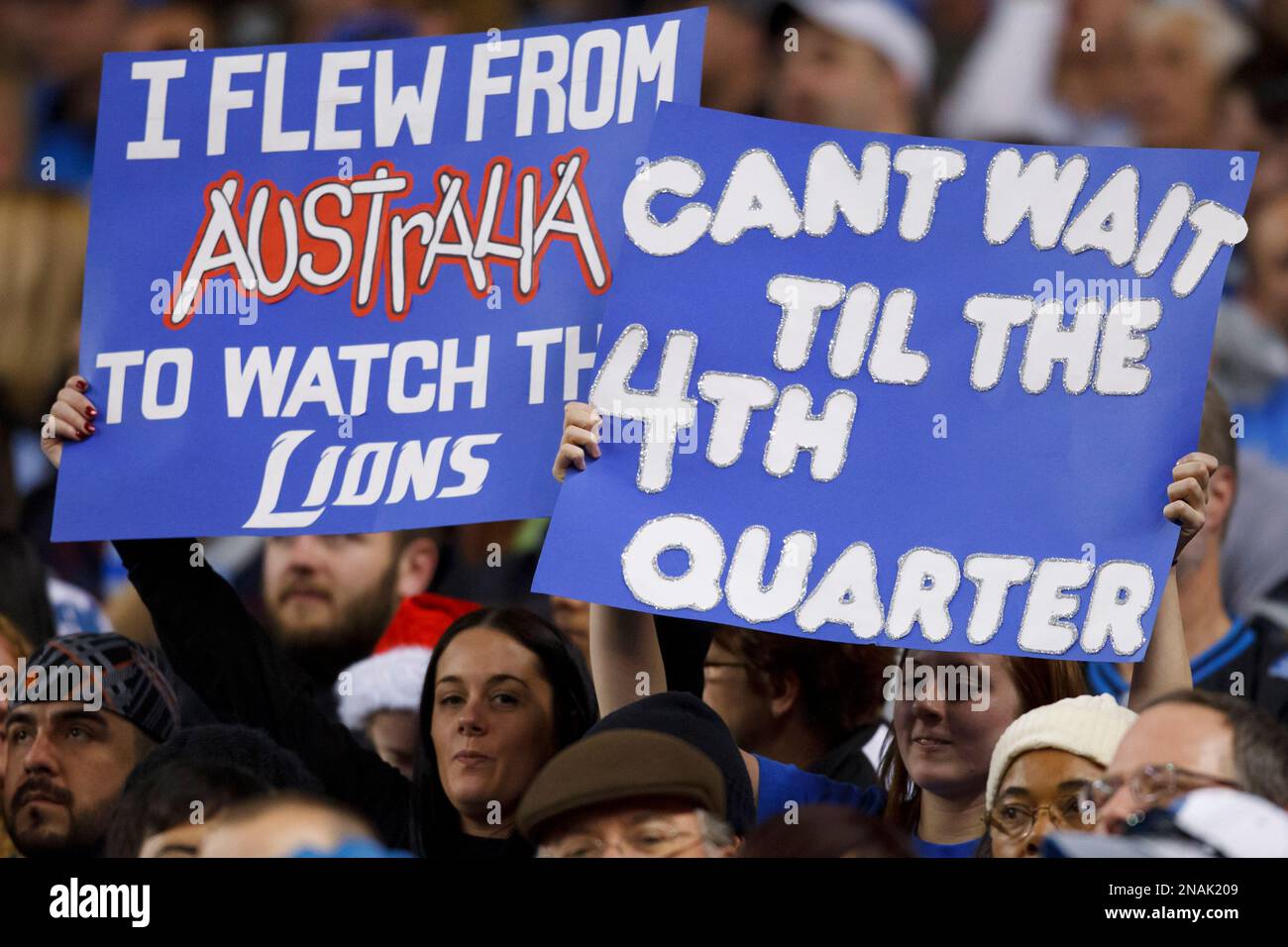 Detroit Lions fans hold up signs for third down against the