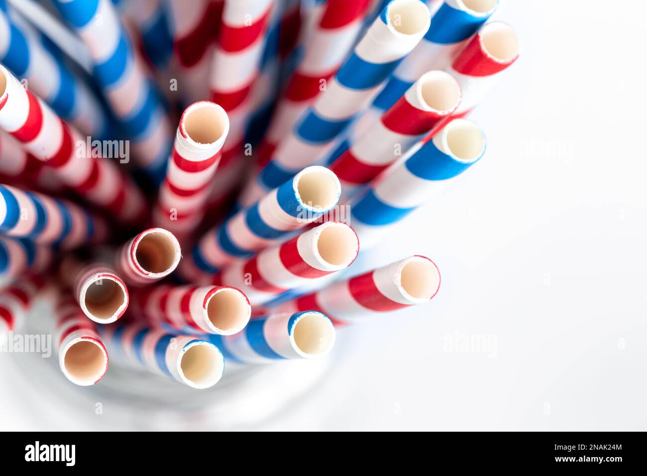 Multi-colored paper straws for drinks close-up on a white background. Stock Photo