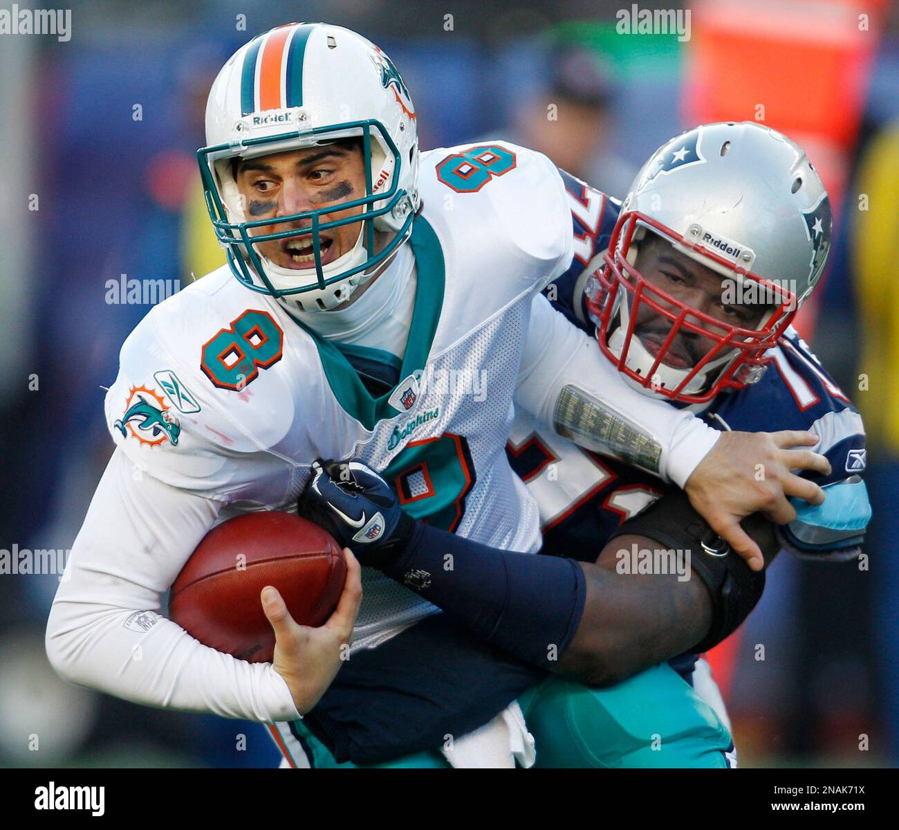 Miami Dolphins quarterback Matt Moore (8) is sacked by New England Patriots  defensive end Brandon Deaderick (71) during the third quarter of an NFL  football game at Gillette Stadium in Foxborough, Mass.
