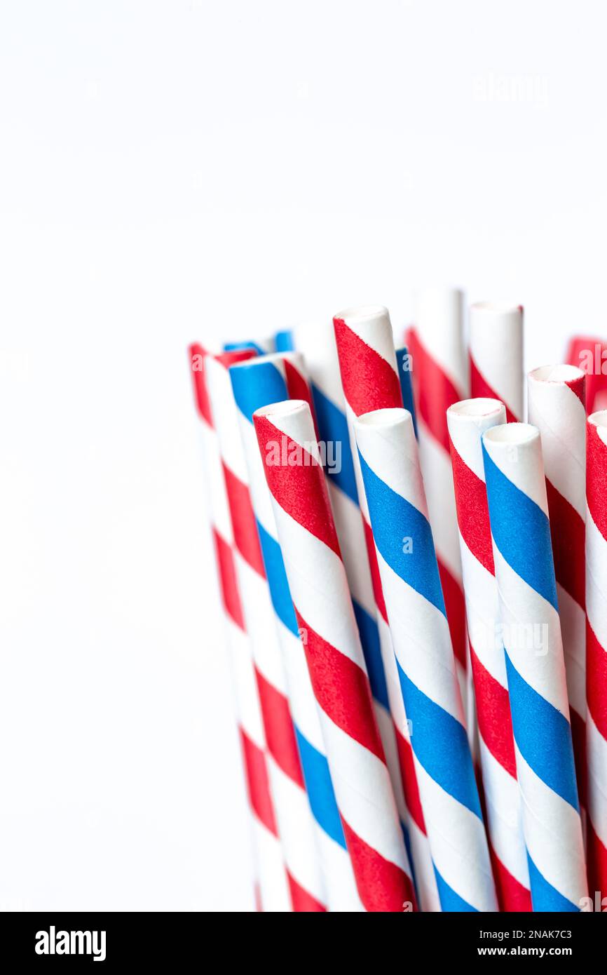 Multi-colored paper straws for drinks close-up on a white background. Stock Photo