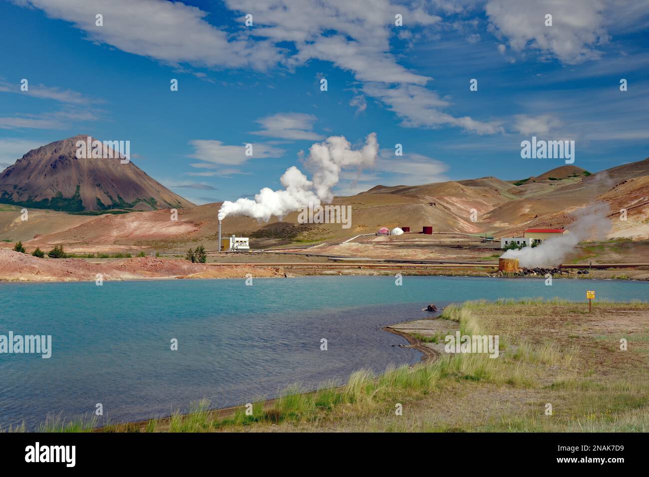 Volcanic mountains, lake with surreal colour, smoking chimneys, pebble ...