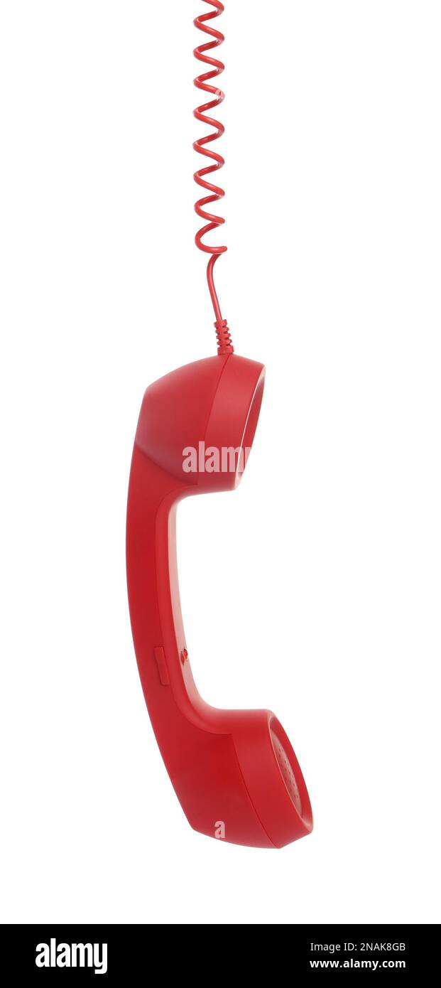 Red corded telephone handset hanging on white background. Hotline