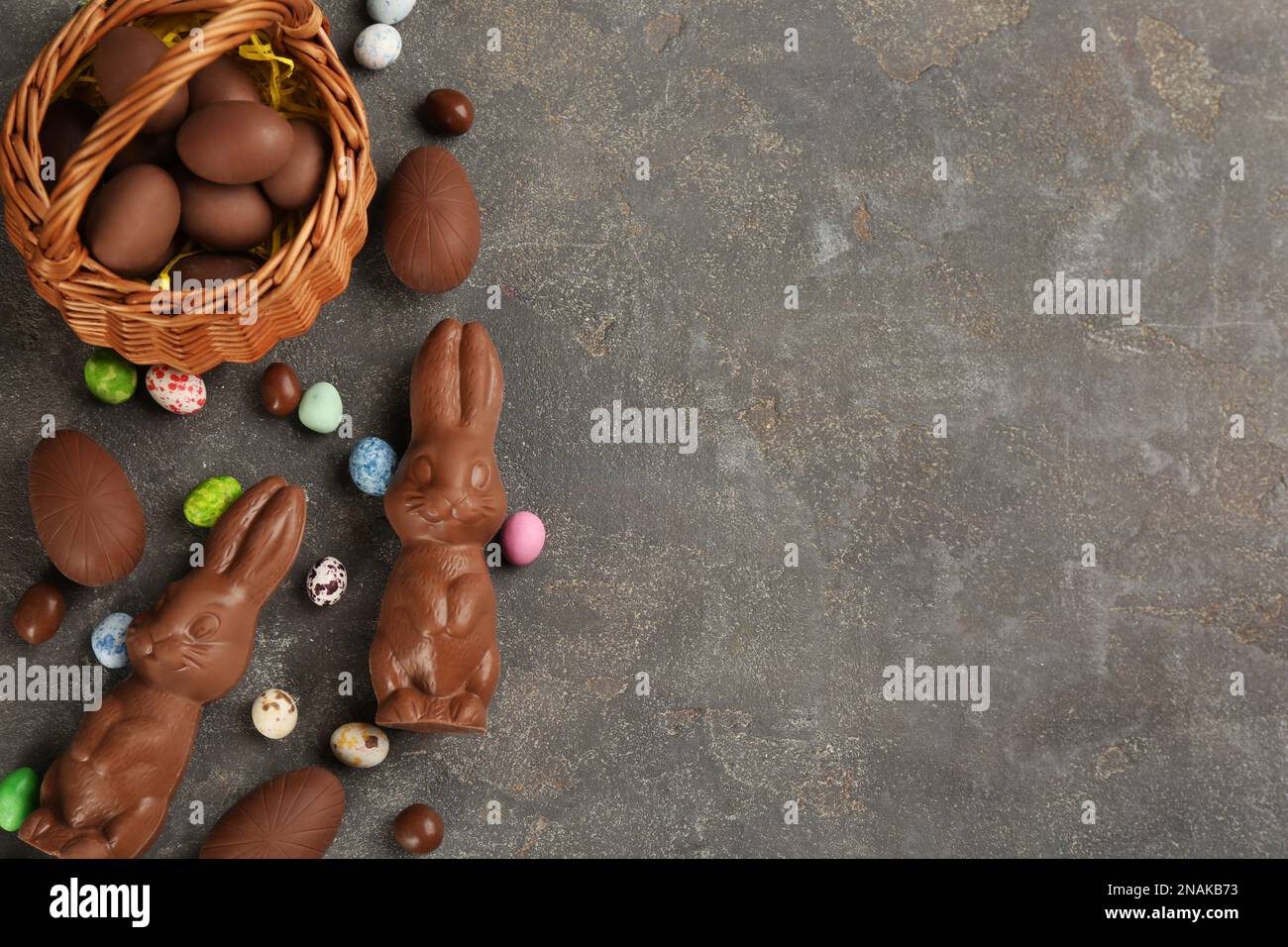 Flat lay composition with chocolate Easter bunnies, eggs and candies on ...