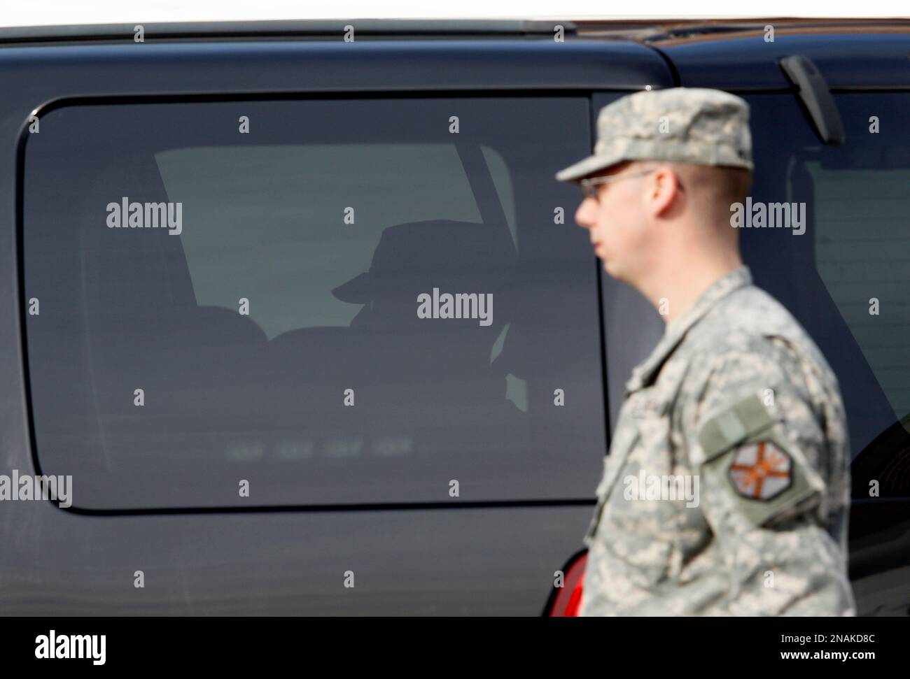 Army Pfc. Bradley Manning sits in the back seat of a departing security  vehicle as a soldier walks by outside a courthouse in Fort Meade, Md.,  Thursday, Dec. 22, 2011, after closing