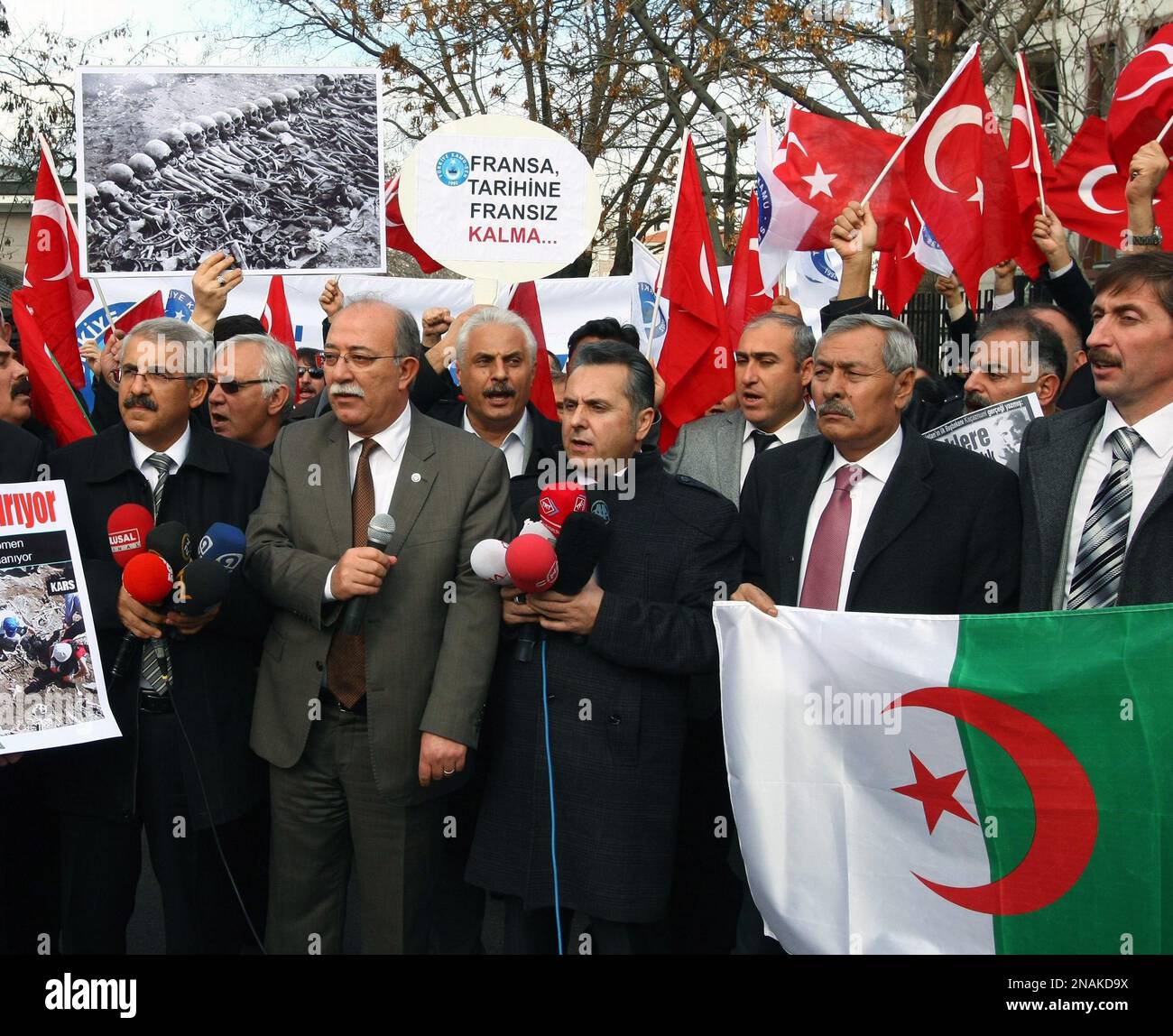 Members of a Turkish union hold Turkish and Algerian flags as they protest  against France outside the French Embassy in Ankara, Turkey, Thursday, Dec.  22, 2011. Turkey is recalling its ambassador to