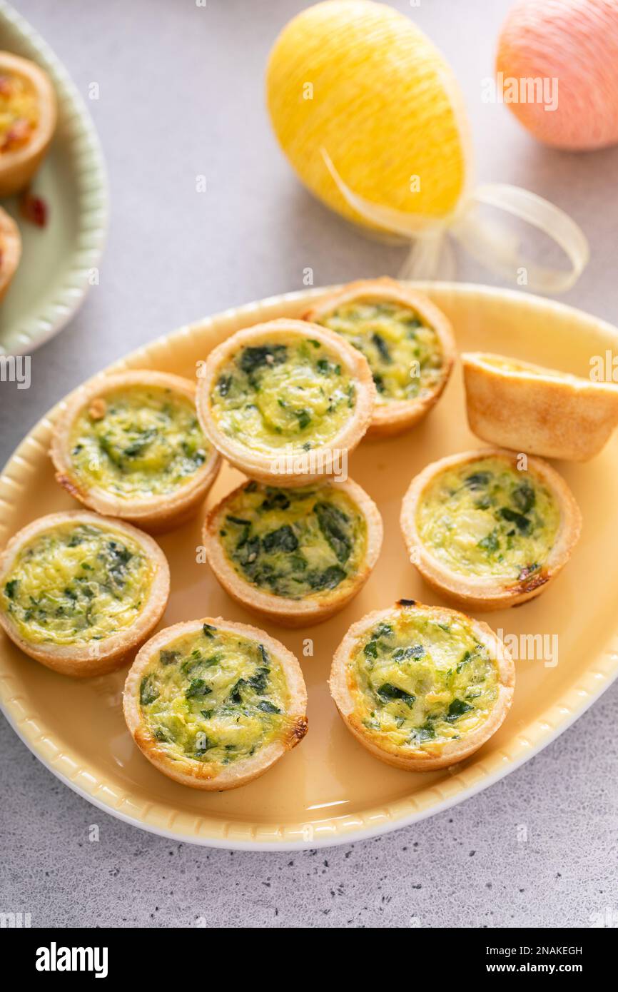 Mini quiches with spinach for Easter brunch, quiche florentine Stock