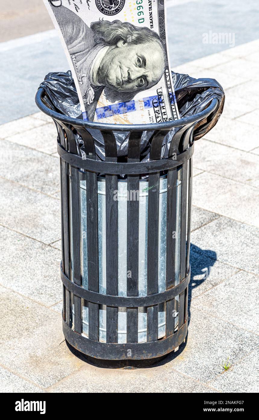 Dollars banknote in the garbage bin. Trash can with american money