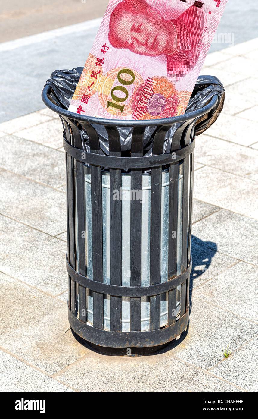 Chinese yuan banknote in the garbage bin. Trash can with chinese money