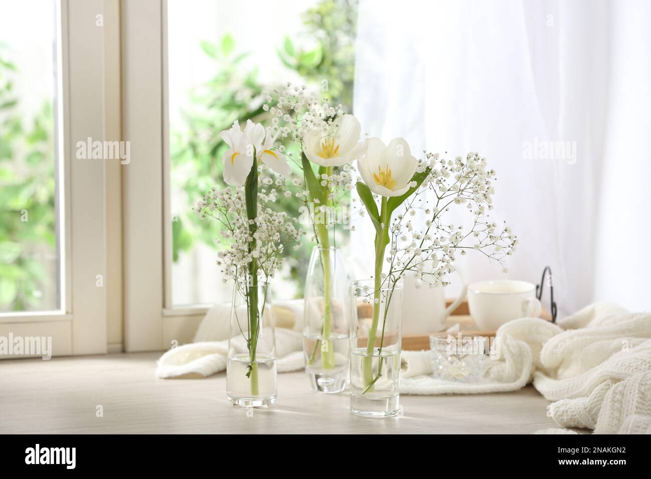 Beautiful fresh flowers on window sill indoors Stock Photo - Alamy