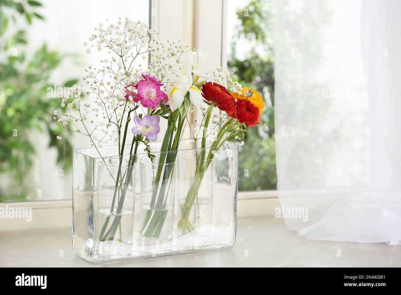 Beautiful fresh flowers on window sill indoors Stock Photo - Alamy