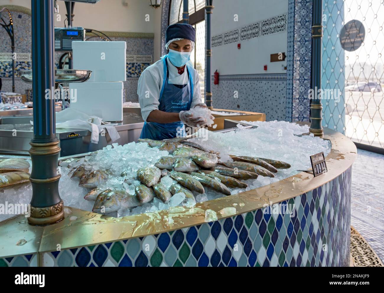 Salesman with sherry fish, Mina District Fish Market, Old Doha Port