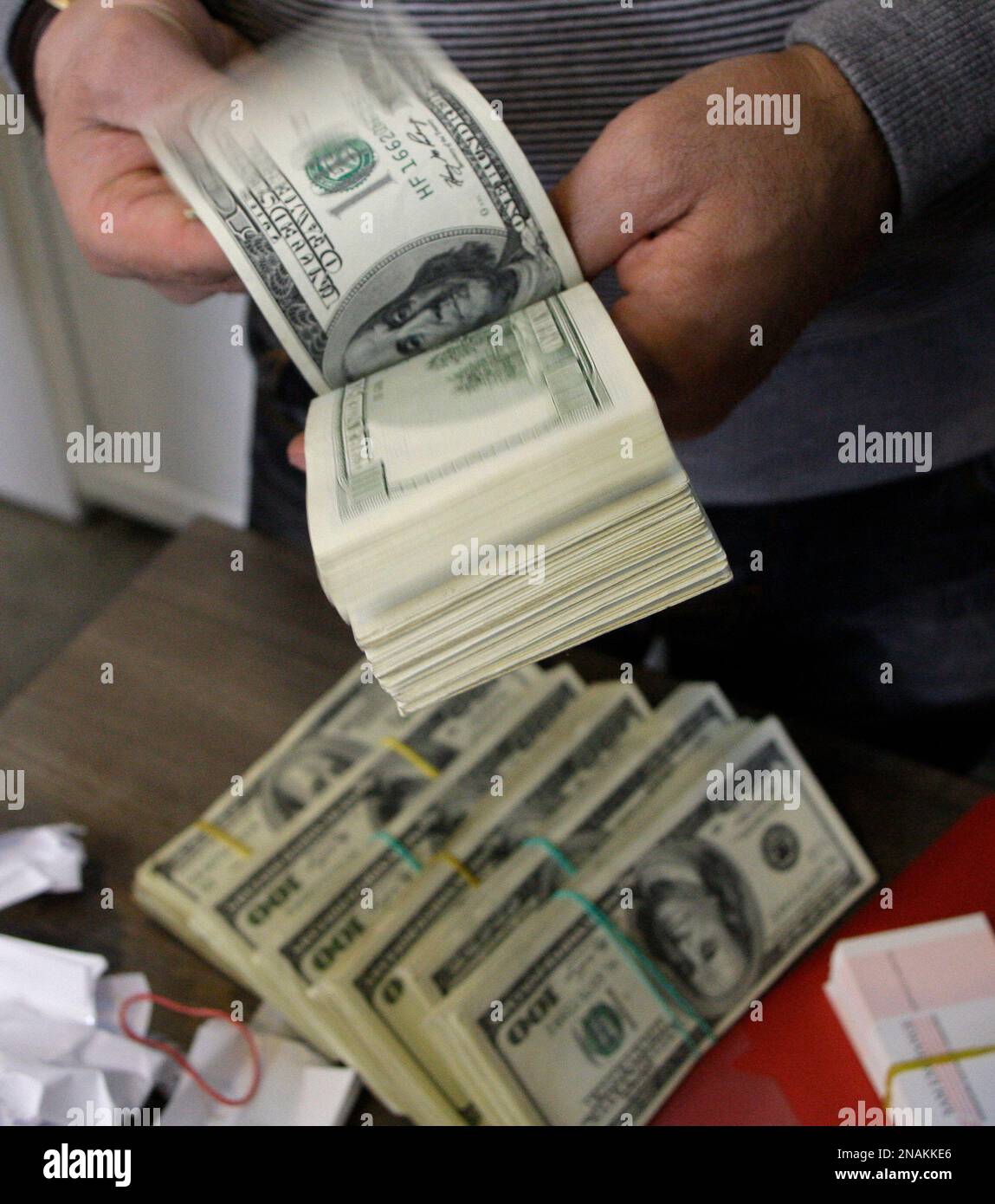 a-currency-exchange-bureau-worker-checks-us-dollars-in-downtown-tehran