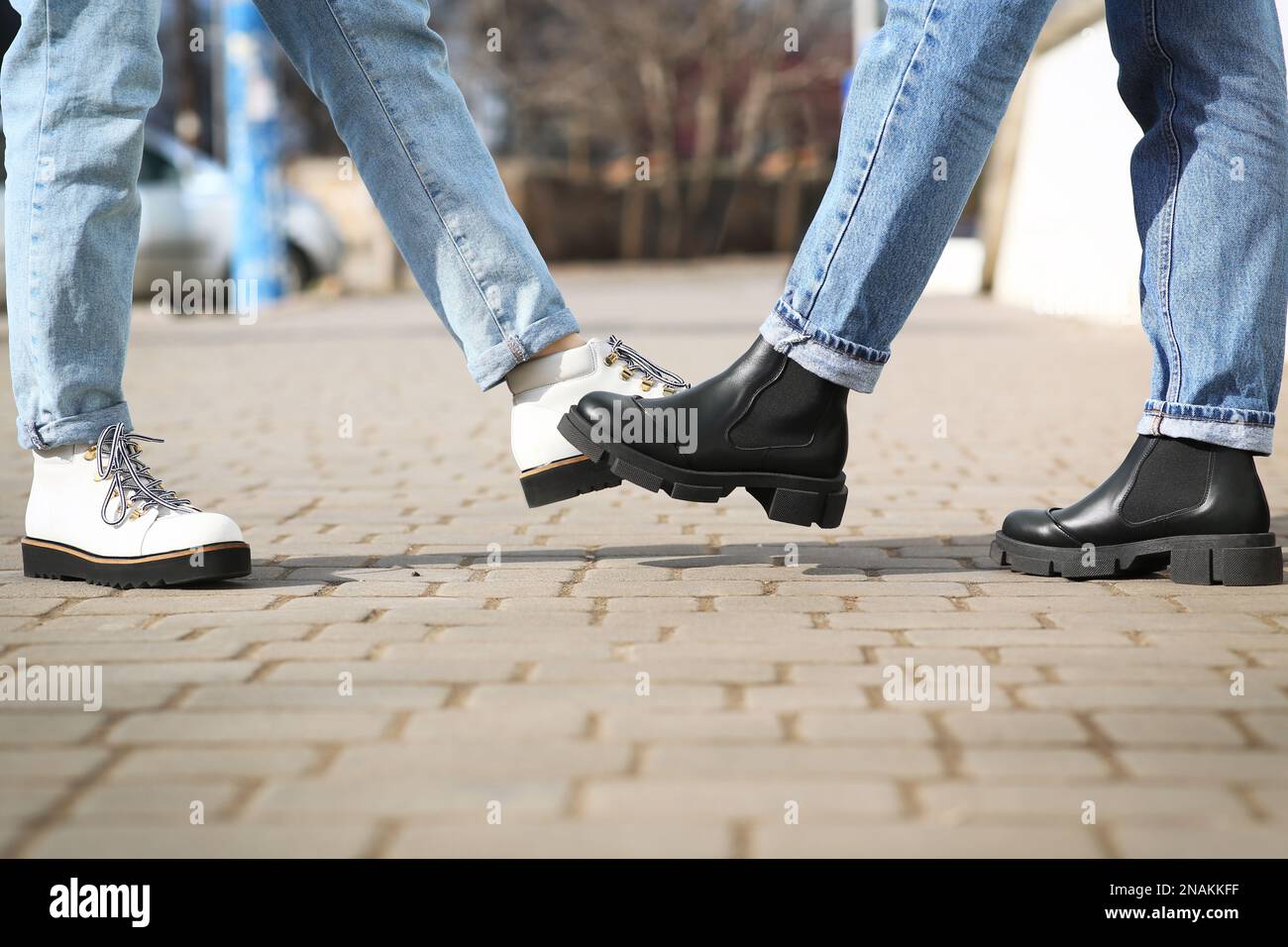 People greeting each other by bumping feet instead of handshake ...
