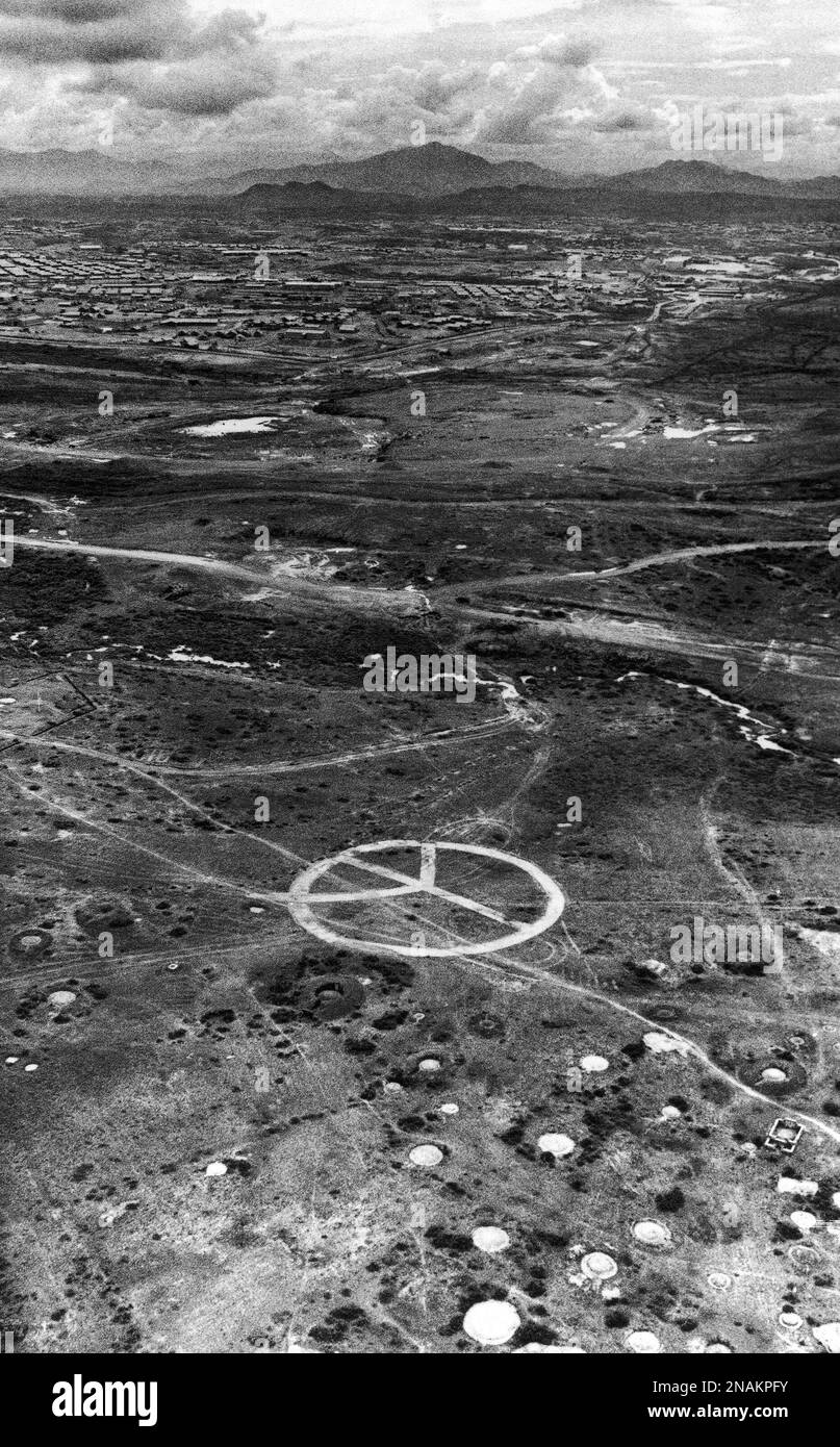 Aerial image if a large peace sign, apparently made with a bulldozer