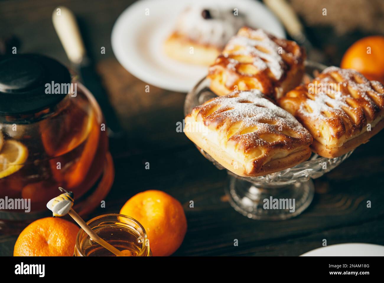 Homemade pastries on beautifully served table decorated in rustic style. Cozy home, tea time, food background Stock Photo