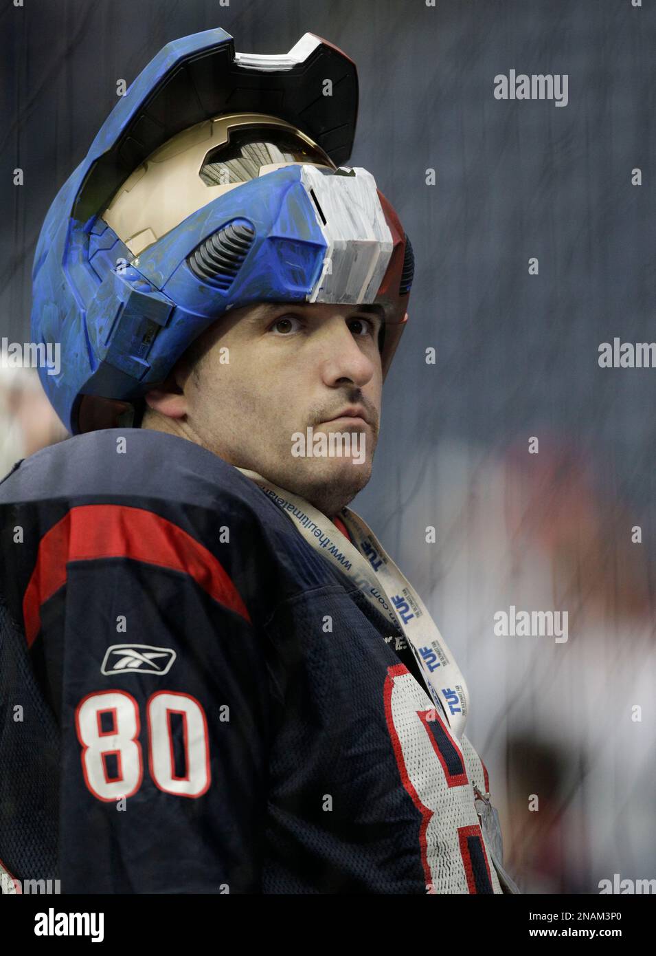 A Cleveland Browns fan wears a dog hat as he watches warmup before