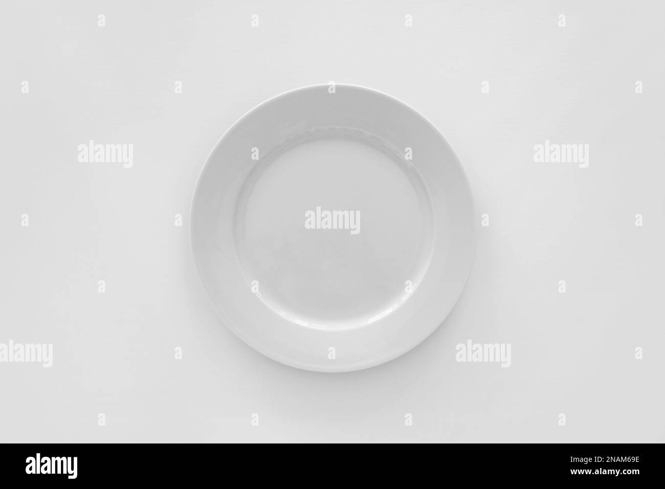 Empty white plate on white background, top view Stock Photo